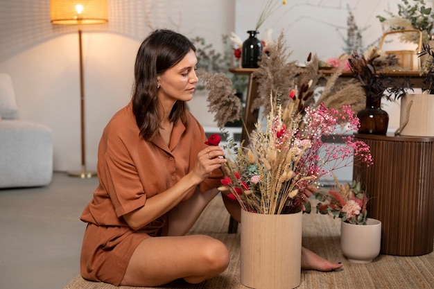 Volle Schussfrau mit getrockneten Blumen