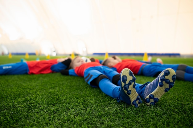 Kostenloses Foto volle schusskinder, die auf gras legen