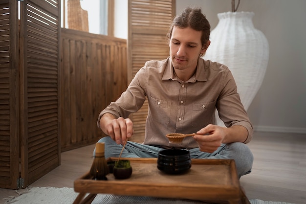 Kostenloses Foto voller schuss mann mit matcha-tee