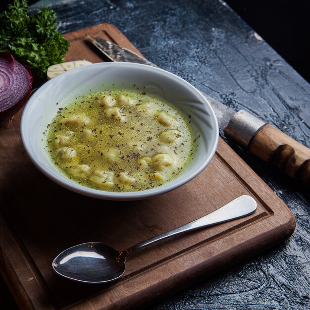 Von oben Dushpara mit Löffel und Messer und Zwiebel in Food Board