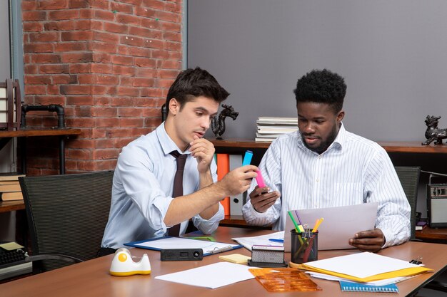 Vorderansicht Arbeitsprozess zwei Geschäftsleute, die im Büro arbeiten working