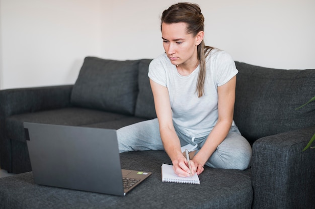 Vorderansicht der Frau, die am Laptop arbeitet