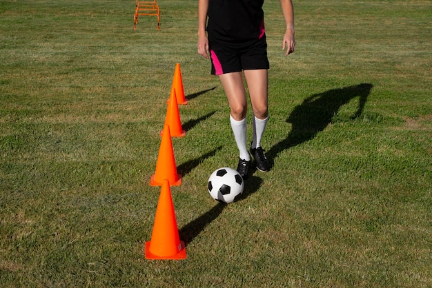 Vorderansicht einer Frau, die Fußball spielt