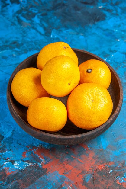 Vorderansicht frische Mandarinen im Teller auf einem blauen Tisch Obstbaum Farbfoto Saft Zitrus