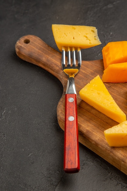 Vorderansicht frischer Käse in Scheiben geschnitten auf dunkelgrauem Essen Foto Essen Frühstück Cips Farbe