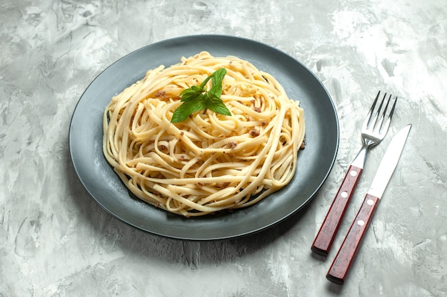 Vorderansicht gekochte italienische Pasta mit Besteck auf weißem Hintergrund