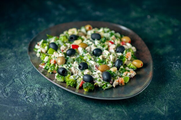 Vorderansicht Gemüsesalat mit Mayononaise und Oliven auf dunkelblauer Oberfläche Mahlzeit Farbe Urlaub Gesundheit Gericht Foto Abendessen