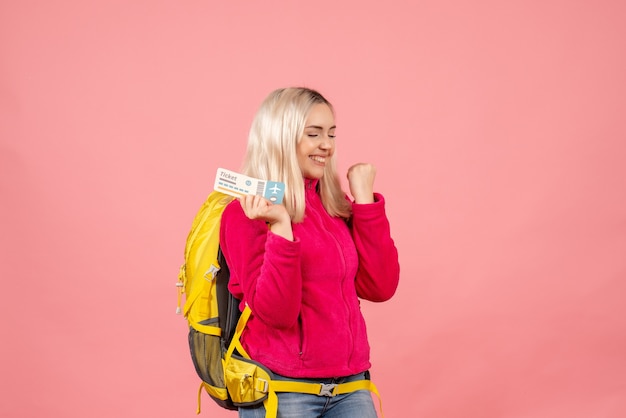 Kostenloses Foto vorderansicht glückliche reisende frau in der freizeitkleidung, die rucksack hält ticket hält