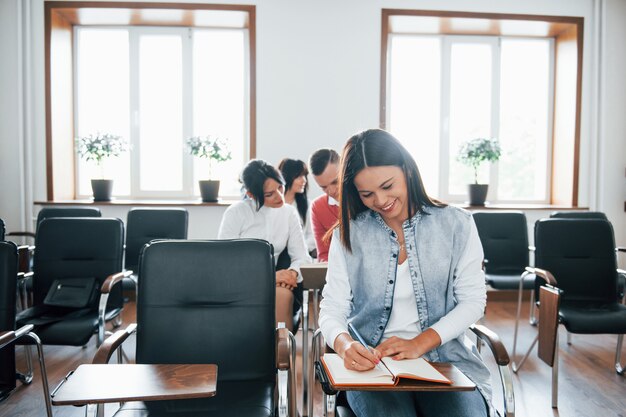 Vorderansicht. Gruppe von Personen an der Geschäftskonferenz im modernen Klassenzimmer tagsüber