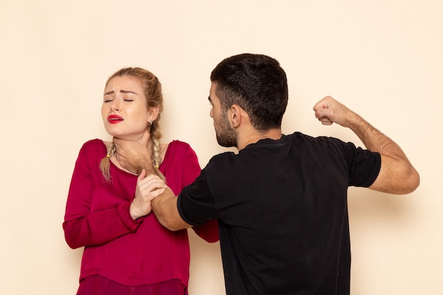 Kostenloses Foto vorderansicht junge frau im roten hemd leidet unter physischen bedrohungen und gewalt auf dem lichtraum weibliches stofffoto