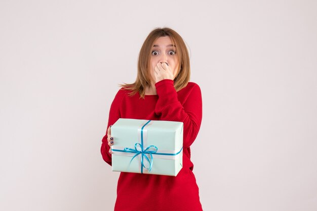 Vorderansicht junge Frau stehend mit Weihnachtsgeschenk