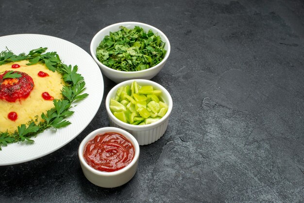 Vorderansicht Kartoffelbrei mit Tomatensauce und Grüns auf dem dunklen Raum