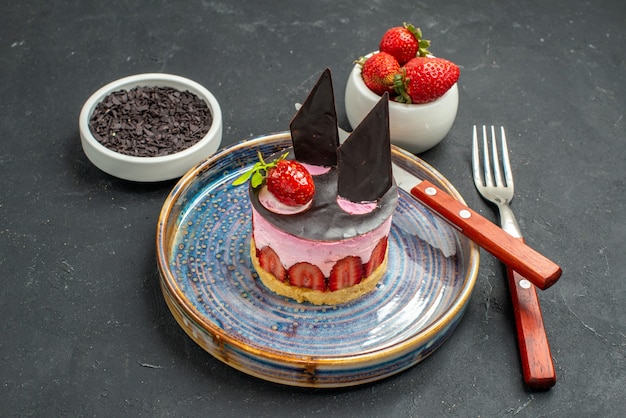 Vorderansicht köstlicher Käsekuchen mit Erdbeeren ein Messer auf Tellerschalen mit Erdbeeren