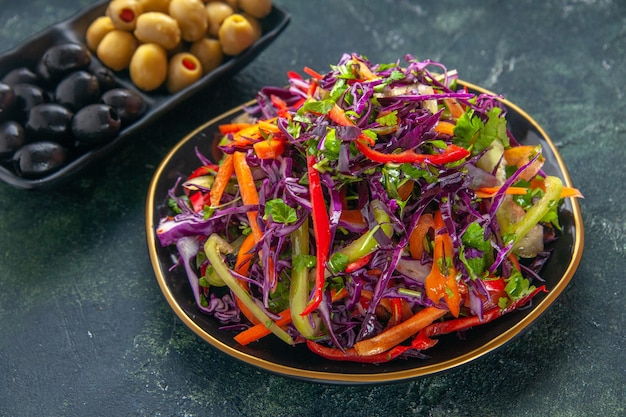 Vorderansicht köstlicher Kohlsalat mit Paprika im Teller auf dunklem Hintergrund