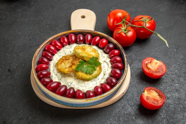 Vorderansicht köstliches Kürbismehl mit frischen roten Hartriegeln und Tomaten auf dunkelgrauem Raum