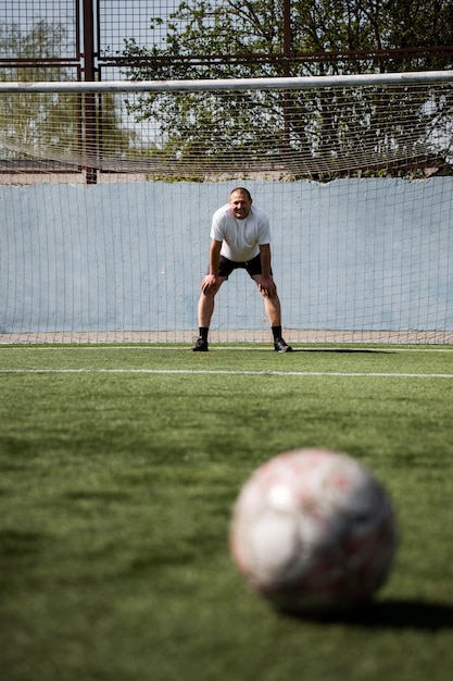 Kostenloses Foto vorderansicht mann, der fußball spielt