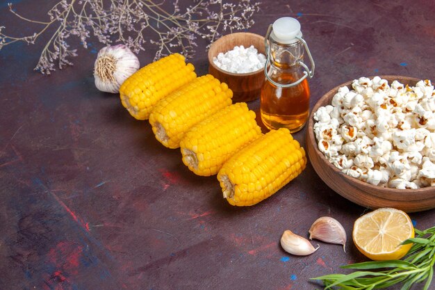 Vorderansicht rohe gelbe Hühneraugen mit frischem Popcorn auf dunkler Oberfläche Snack Popcorn Film Pflanzenmais