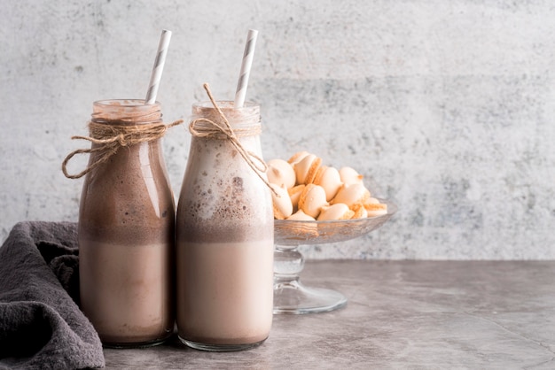 Vorderansicht von Desserts mit Strohhalmen und Macarons