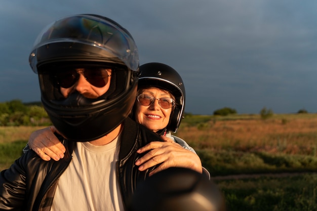 Kostenloses Foto vorderansicht von menschen mit motorrad im freien