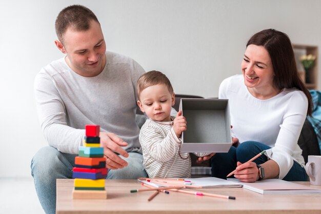 Vorderansicht von Mutter und Vater mit Kind zu Hause