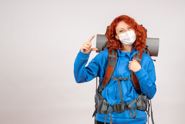 Vorderansicht weiblicher Tourist in Maske mit Rucksack