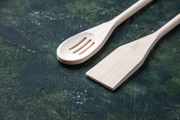Vorderansicht weiße Plastikgeschirr auf dunklem Hintergrund Plastikgabelbesteck Holzmesser Küche Essen Fotos