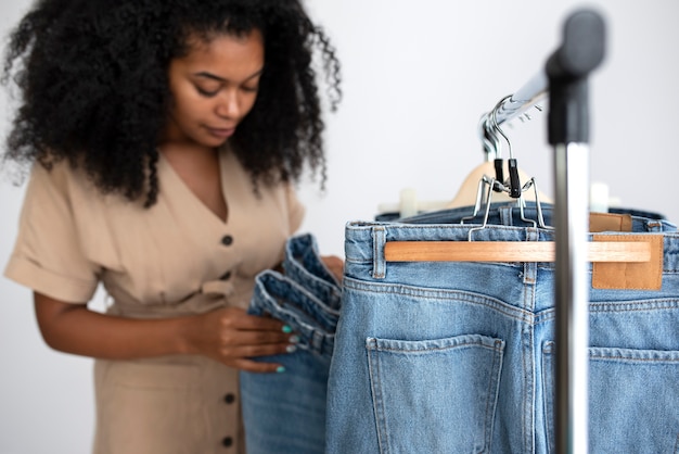 Kostenloses Foto vorderansichtfrau, die jeans betrachtet