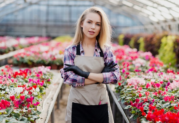 Vorderansichtfrau mit dem Schutzblech, das für Blumen sich interessiert