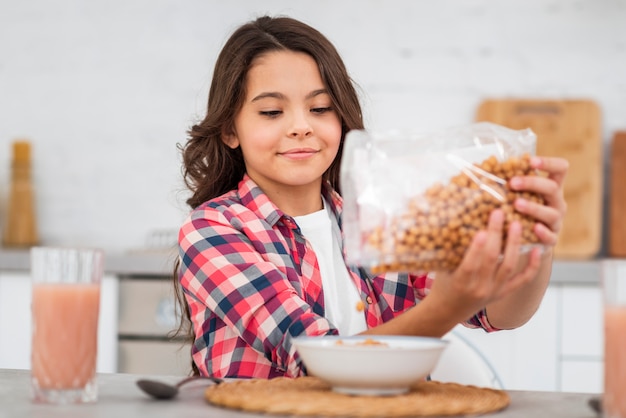 Kostenloses Foto vorderansichtmädchen, das frühstück zubereitet