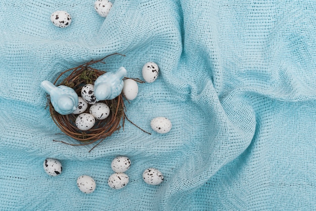 Wachteleier im Nest auf blauem Stoff