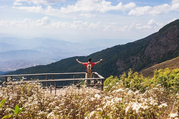 Wanderer, der die Arme auf die Aussichtsplattform hebt