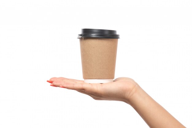 Weibliche Hand der Vorderansicht, die Kaffeetasse auf Weiß hält