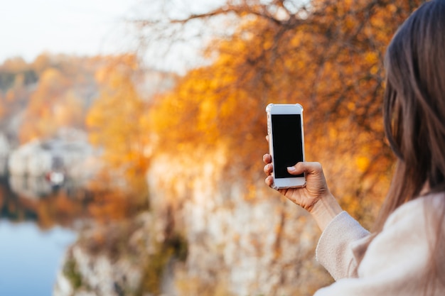 Weibliche Hand, die ein Telefon, schwarzen Bildschirm anhält