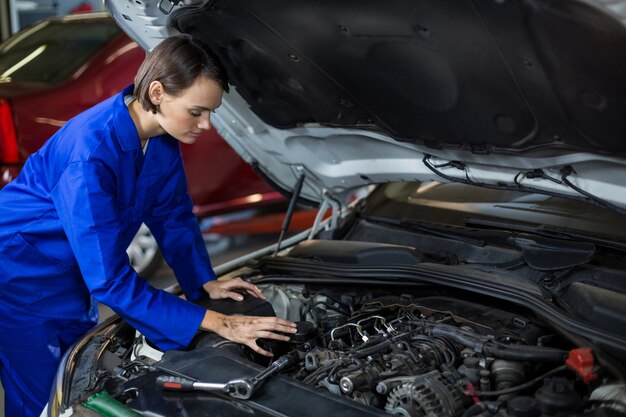 Weibliche Mechaniker ein Auto Prüfung