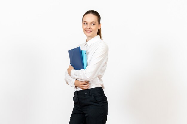 weiblicher Büroangestellter in der weißen Bluse, die Dokumente mit Lächeln auf Weiß hält