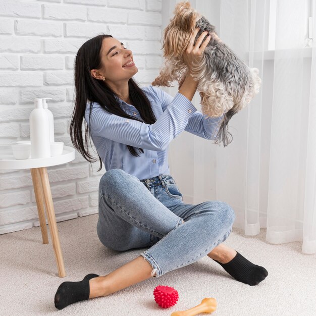 Weiblicher Influencer zu Hause, der Spaß mit Hund hat