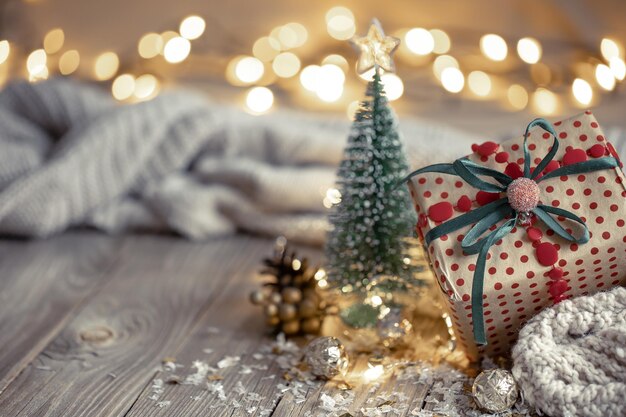 Weihnachtskomposition mit festlichem Geschenk auf verschwommenem Hintergrund