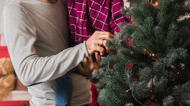 Kostenloses Foto weihnachtskonzept mit rührendem weihnachtsbaum der familie