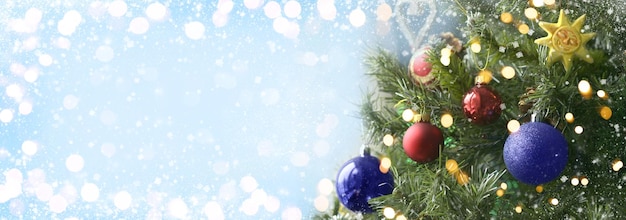 Weihnachtskugeln und überraschungen auf zweigen des weihnachtsbaums und leuchtenden lichtern grußkarte