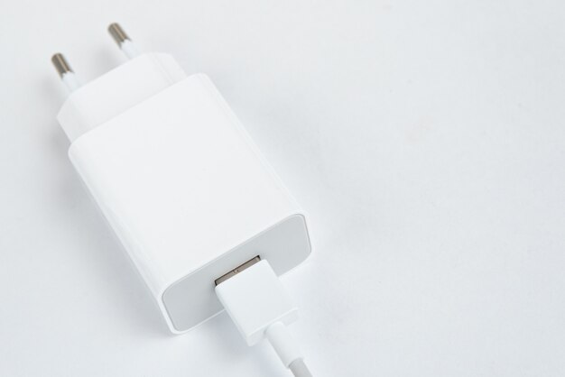 Weißes Handy-Ladegerät auf dem weißen isolierten Hintergrund - Mit USB-Kabel