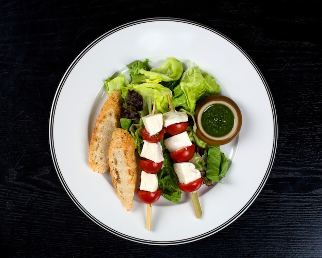 Weißkäse mit Tomate auf Stöcken und Brot