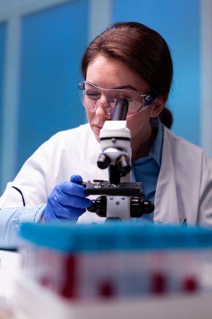 Wissenschaftler, der die Mikroskopapotheke in Labor, Experiment, Expertise, Impfstofftests einstellt