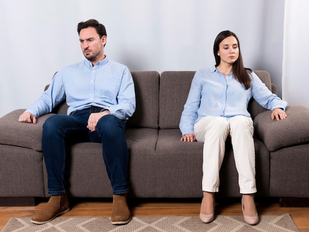 Wütender Mann und Frau sitzen auf der Couch