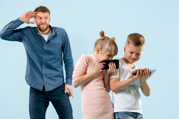 Wütender Vater schimpft zu Hause mit seinem Sohn und seiner Tochter.