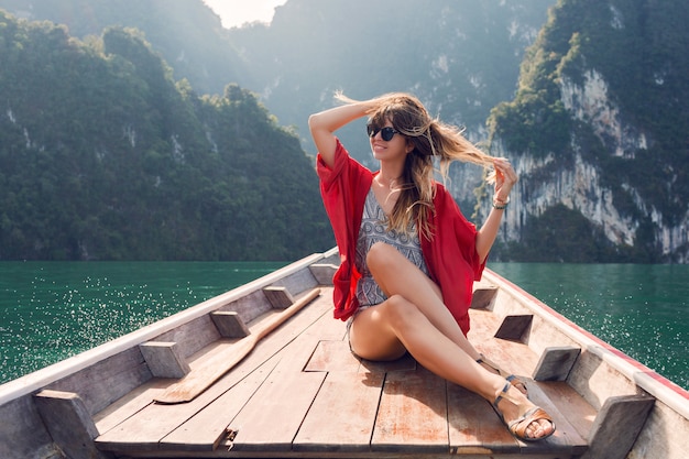 Wunderreisende Frau, die wilde Natur auf langer Schwanzbootfahrt im Khao Sok Nationalpark genießt. Ausflug in Thailand. Schönes Mädchen im tropischen Urlaub.