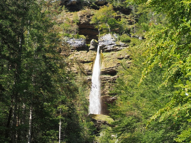 Wunderschöne Landschaft des Wasserfalls, der durch die mit Moos bedeckten Felsen im Wald geht