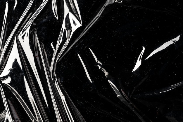 Zerknitterte Plastikfolie Textur auf einem schwarzen Hintergrundbild