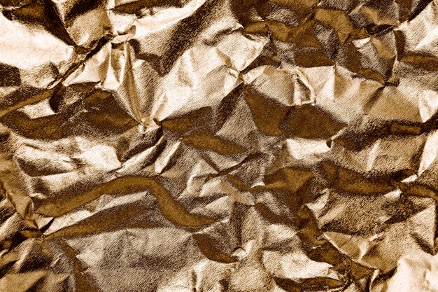 Zerknittertes Goldpapier strukturierter Hintergrund