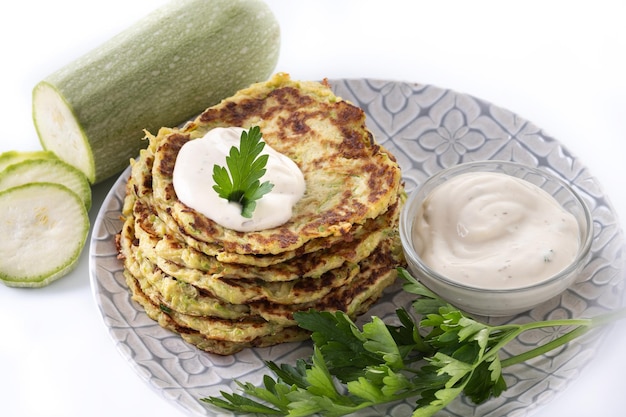 Zucchini-Krapfen mit Joghurtsauce isoliert