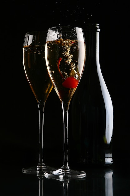 Zwei elegante Gläser mit Champagner und Kirsche